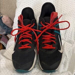 Black Sneakers with Red Laces and Teal Accents